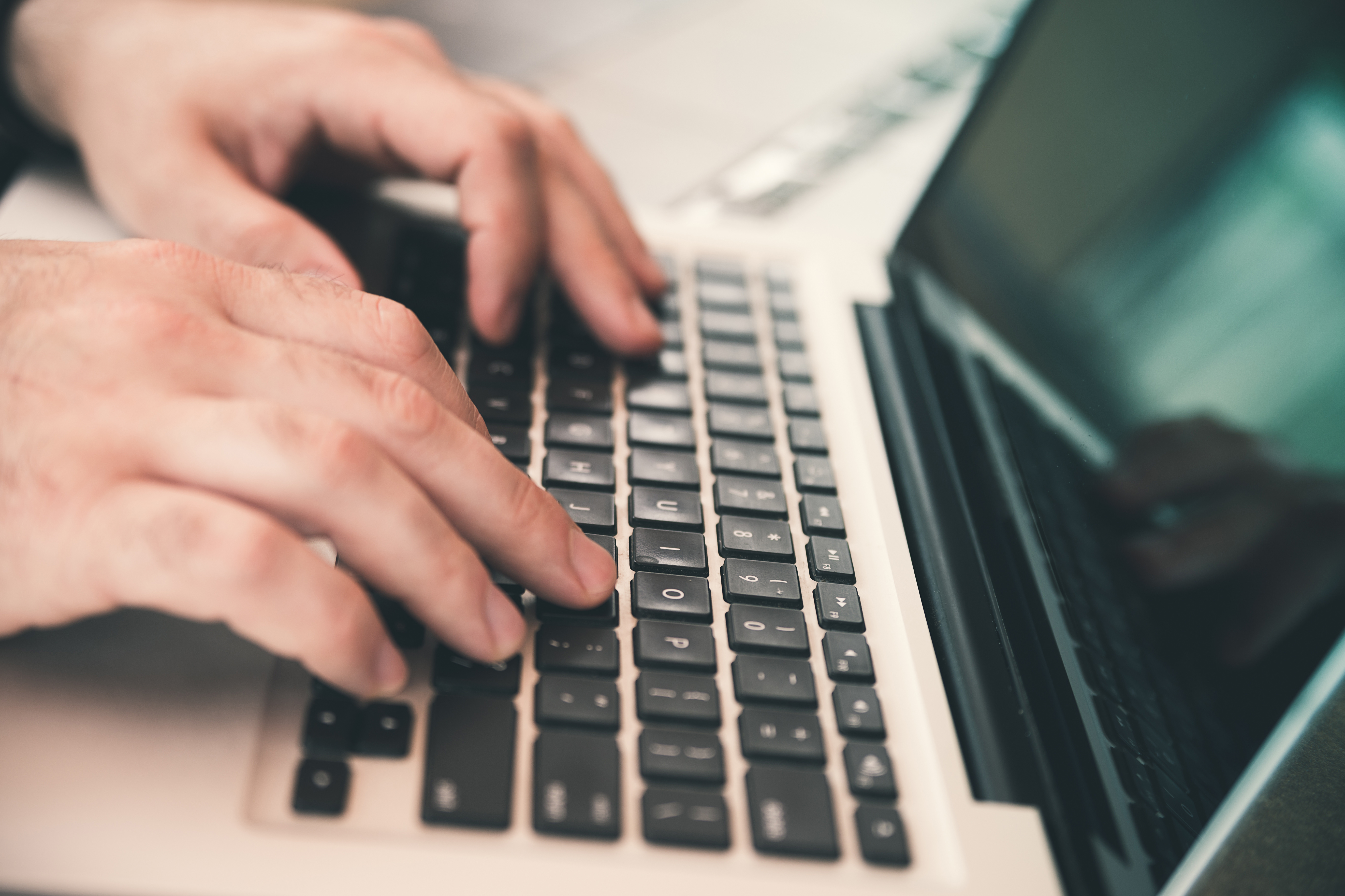 Hands typing on a keyboard