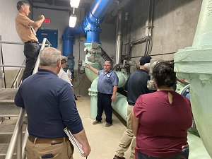 During a CPE event in South Carolina an operator stands in the pipe gallery of a water treatment plant and answers questions from one of the Comprehensive Performance Evaluation (CPE) teams