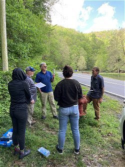 Water distribution system operator speaking with several distribution system optimization workshop participants during a sampling event as part of the workshop