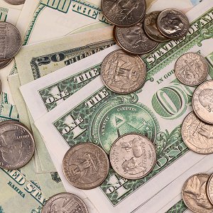 US coins and bills scattered on a table